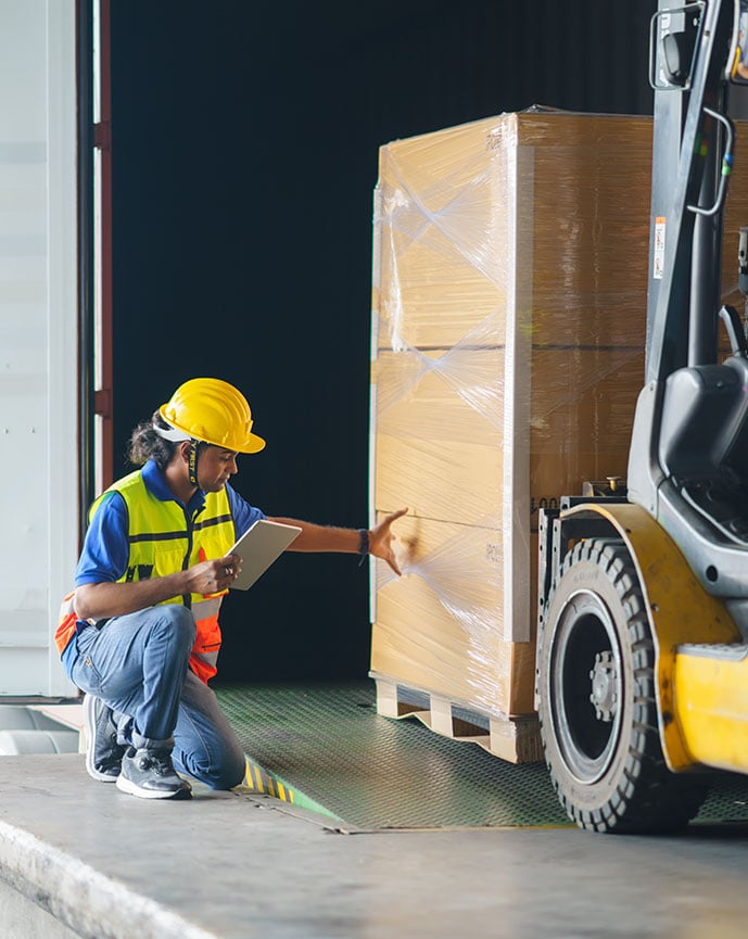 Warehouse worker and safety inspector with digital tablet manage the process